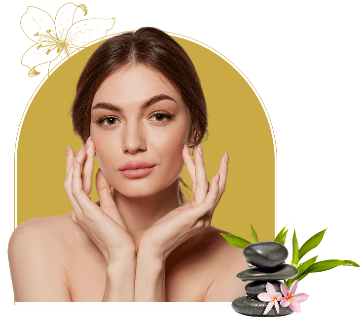 Woman posing with spa stones and flowers.